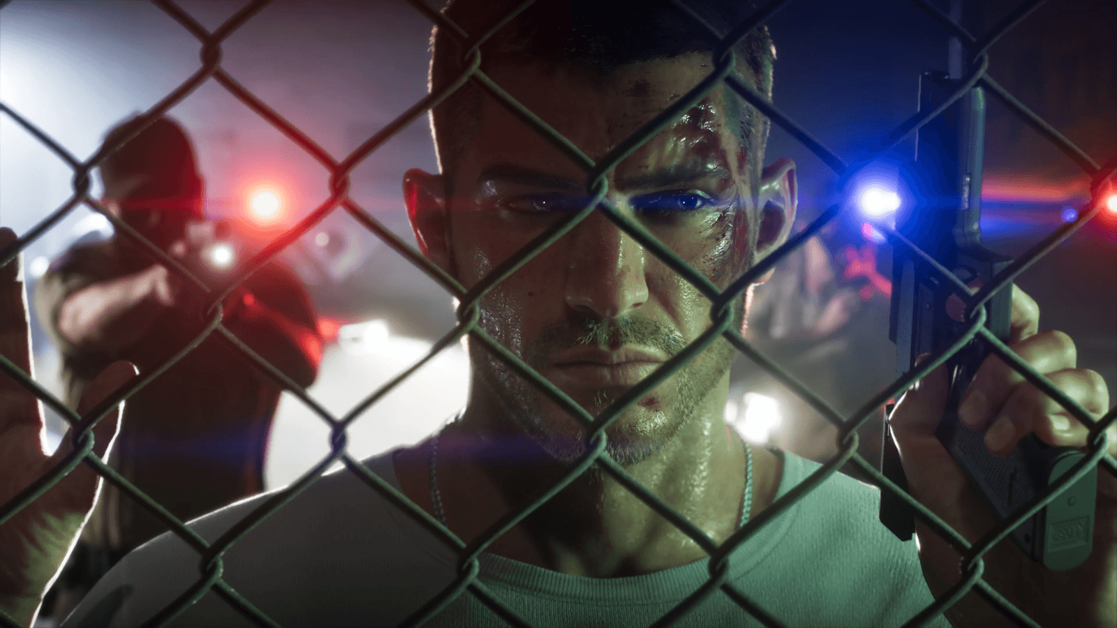 Jason bloodied behind a chain-link fence with police lights closing in, in GTA 6, official screenshot