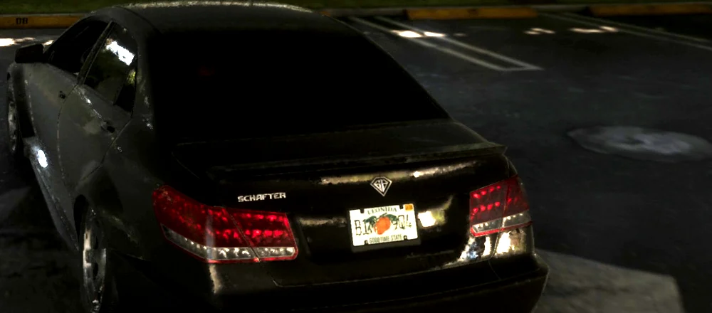 The rear of a black Benefactor saloon in a parking garage with SCHAFTER lettered on the boot lid and a Leonida licence plate