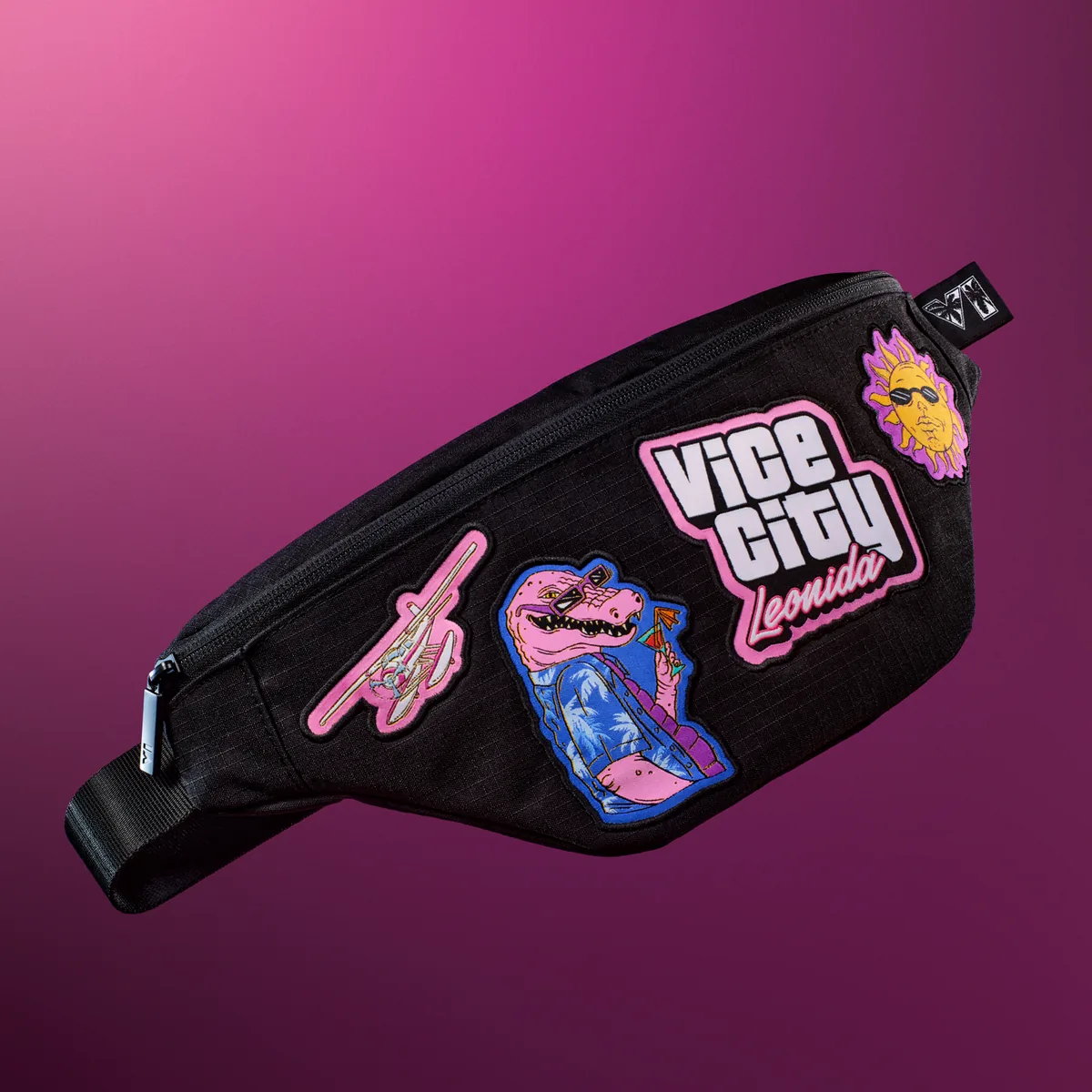 A black Leonida Keys crossbody bag with Vice City, Macca the Gator, sun and seaplane patches