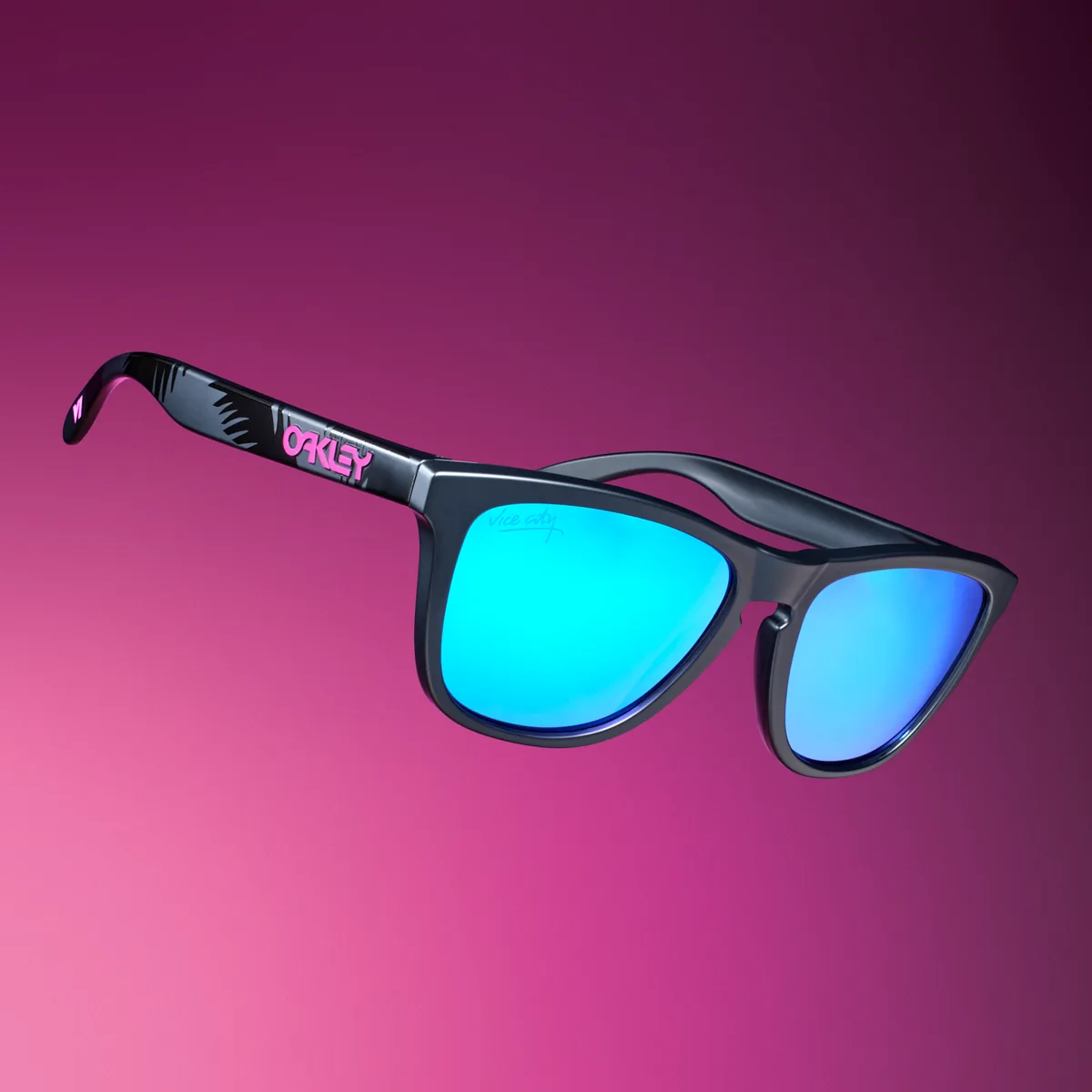 Matte black Oakley Frogskins sunglasses with blue Prizm Sapphire lenses and a pink logo on the arm