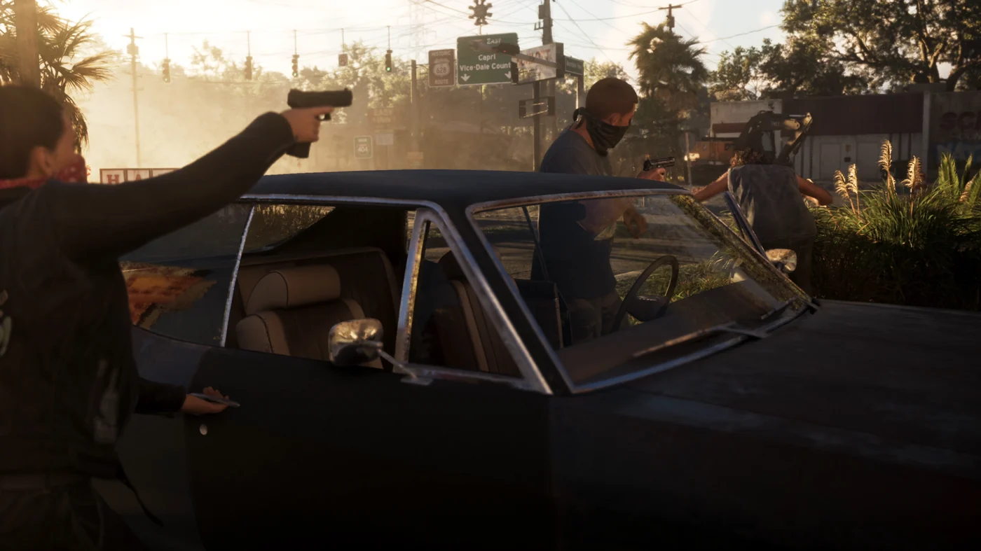 Lucia in a bandana aiming a semi-automatic pistol over an open car door in daylight while another figure fires nearby