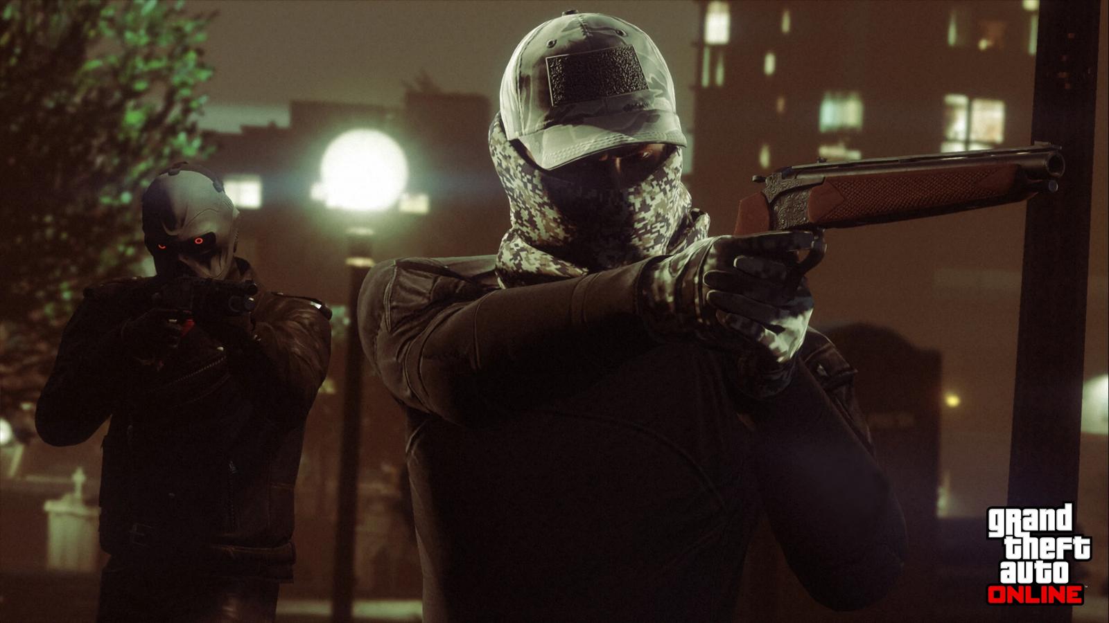Two masked players aiming weapons on a Los Santos street at night in GTA Online