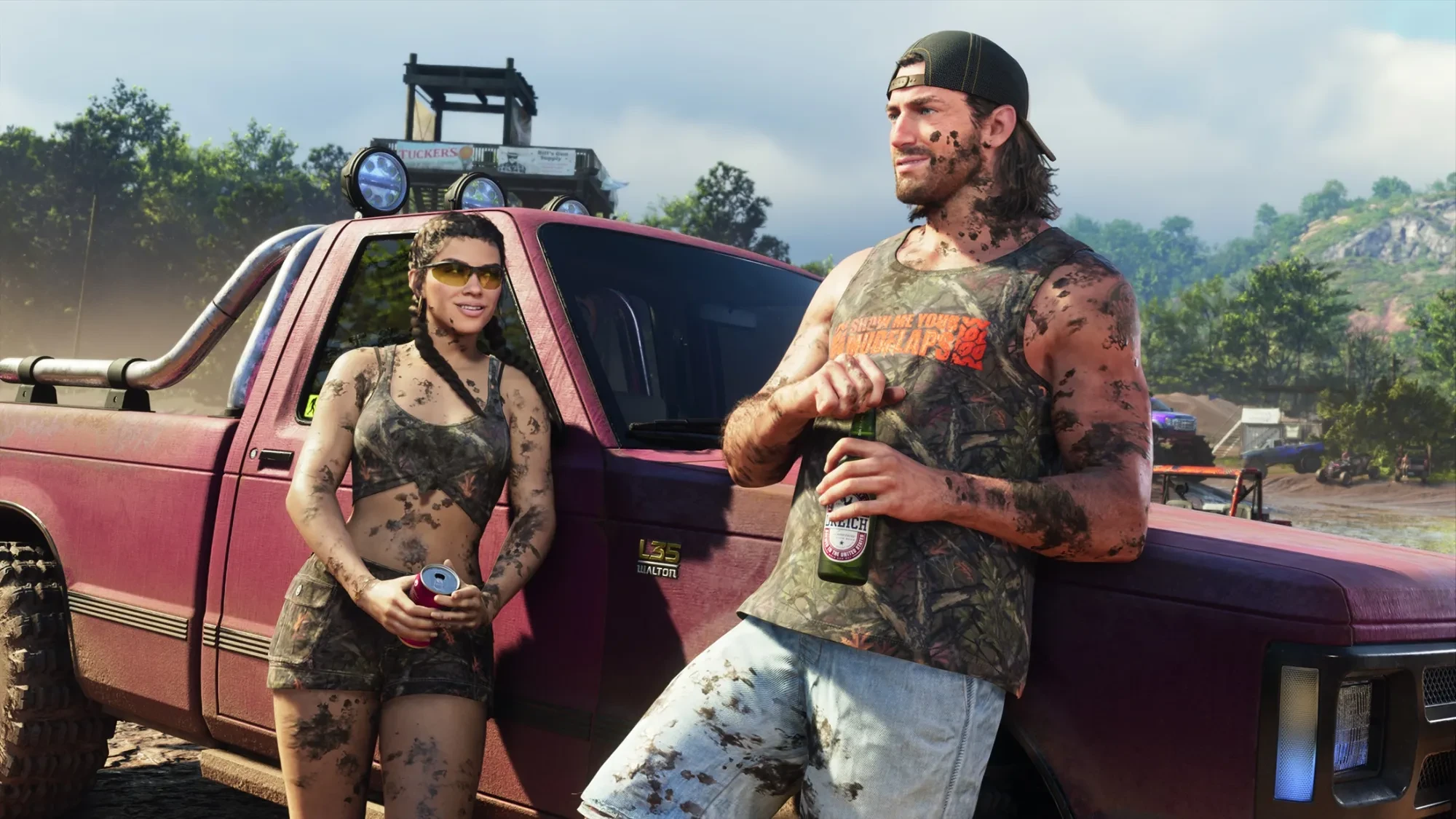 Jason and Lucia, splattered with mud, lean on a red Walton L35 pickup at a dirt track, Jason with a bottle of beer and Lucia with a can